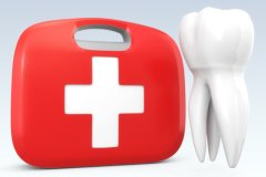A red dental emergency kit next to an oversized tooth.